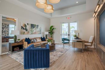 a living room with blue furniture and a door to a balcony